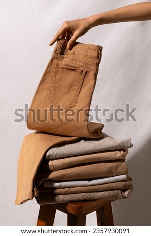 Beige casual pants. light brown pants. Beige pants background. men pants advertisement. pant ad. copy space. Casual jeans pant. Fashion, style. clothes advertisement concept. Beige female denim.