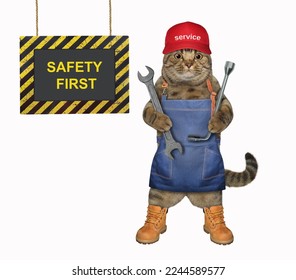 A beige cat auto mechanic in a red cap is holding car wrenches. White background. Isolated. - Shutterstock ID 2244589577