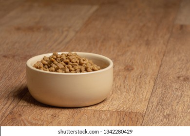 Beige Cat And Dog Food Bowl On The Floor.