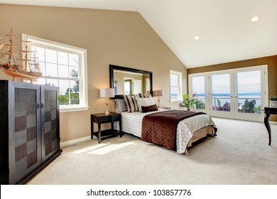 Beige Classic Large Bedroom With Water View And Carpet.