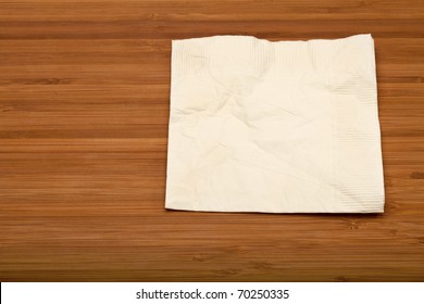 Beige Cocktail Napkin On Wooden (Bamboo) Table