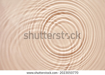 Beige cream texture with beautiful circles and ripples, abstract background for cosmetics