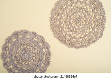 Beige crochet doilies on a pale yellow background