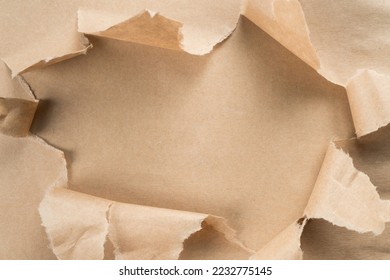 Beige crumpled packaging paper unwrapping from center, ragged paper. Unpacking and bursting from the center. Presents for holidays. Sustainable resource, eco friendly. Overlay, copy space, top view - Shutterstock ID 2232775145