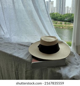 Beige Floppy Hat On The Book