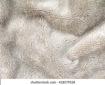 Beige Folded Fluffy Polyester Cozy Fleece Fabric Background