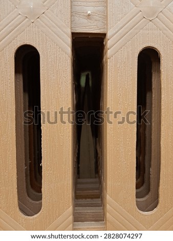 Beige Geometric Architectural Surface with Repeating Openwork Pattern and Texture
