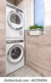 Beige High Gloss Bathroom With Washer, Clothes Dryer And Window