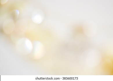 Beige ivory background with soft glowing lights and beautiful bokeh with shine lights. Backdrop for wedding cards 