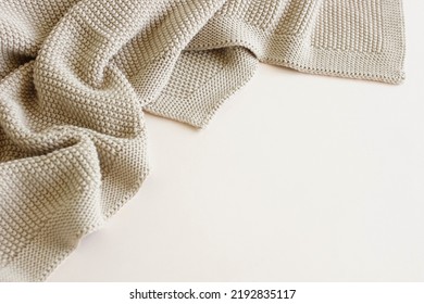 Beige Knitted Blanket On Beige  Background With Copy Space.Autumn, Winter  Template.Flat Lay, Top View