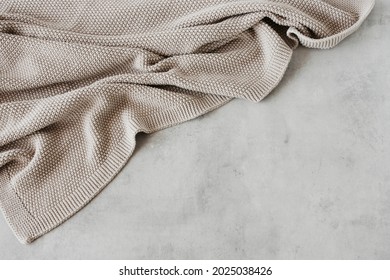 Beige knitted blanket on gray concrete background with copy space.Autumn, winter  concept.Flat lay, top view - Shutterstock ID 2025038426