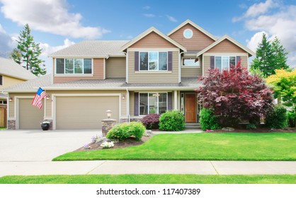 Beige Large Luxury House With Summer Landscape With Blue Sky And American Flag.