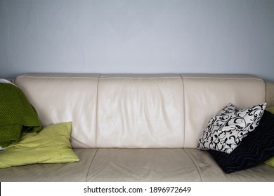 Beige Leather Couch With Pillows And Blanket. No People, Empty. 