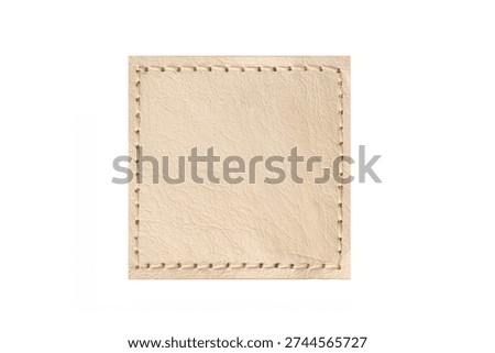 Beige leather patch with stitched border isolated on light background. Square blank label texture. Minimal leather badge template for branding, clothing tag or craft design.