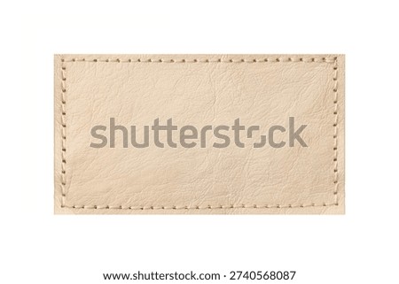 Beige leather patch with stitching isolated. Rectangular label texture detail. Blank stitched badge on light background. Natural leather surface closeup. Template for branding and craft design.