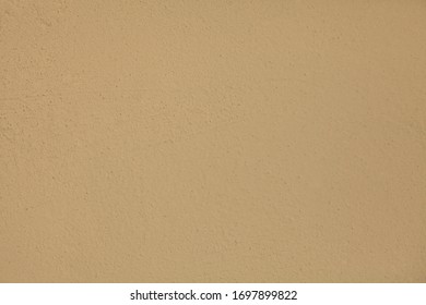 Beige Or Light-brown Wall, Texture, Background. The Building Wall, Painted With Water-based Paint. Pale (flat) Surface In Cacao Color