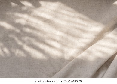 Beige linen fabric texture with folds and a natural floral sunlight shadows, aesthetic summer wedding bohemian background - Shutterstock ID 2306348279