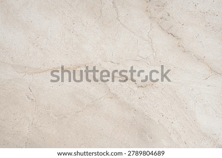 A beige marble background with subtle brown veining and a natural stone texture. Concept for a luxury and elegant surface for a banner or advertising display. Top view, copy space.