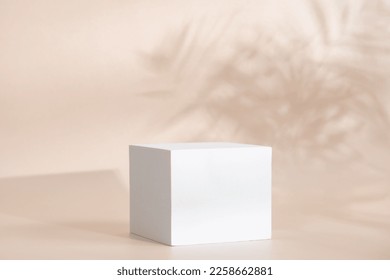 Beige pastel background for product presentation with shadow, tropical palm leaves and light. Podium, stage pedestal platform for cosmetic product. Empty square podium. Mockup. - Shutterstock ID 2258662881
