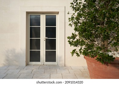 Beige Pvc Door With Glass At The Facade Of A Modern Building.