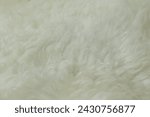 beige sheepskin texture with soft hairs, natural fur for designer, the concept of processing, production of furrier products, stress relief, psychological stress