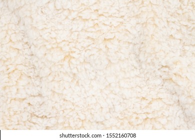 Beige sherpa textured plush fabric material for a background or texture for your images or text