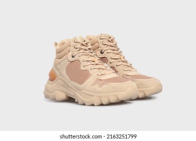 Beige sport high soled women's basketball shoes, sneakers, 
				sports shoes, boots for female isolated on white background. Footwear, pair of running training shoes. Mock up, template