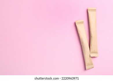 Beige sticks of sugar on pink background, flat lay. Space for text - Shutterstock ID 2220963971