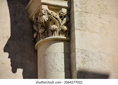 beige stone column head in neo romanesque style. stone textures. fine details od sculpting. religious architecture. faith and religion concept. architectural detail. travel and tourism. Pecs, Hungary.