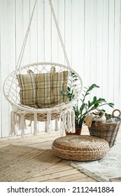 Beige String Swing With Cushion. Wicker Circle, Rug And Plants On The Wooden Floor In The Studio. Home Bright Interior