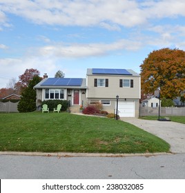 Beige Suburban Split Level High Ranch House Autumn Day Residential Neighborhood Blue Sky Clouds USA