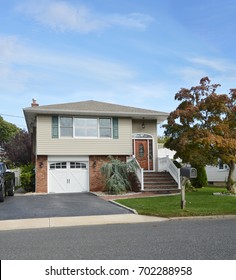 Beige Suburban Split Level Home Blue Sky Clouds USA