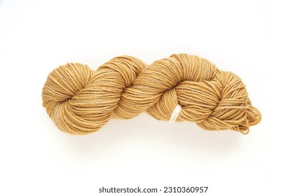 Beige twisted yarn hank on a white background, hand dyed wool skein flat lay top view - Powered by Shutterstock