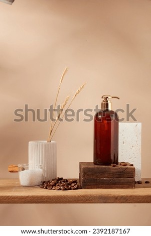 Beige wall background with pump bottle on wooden podium, coffee beans and bath salt on wooden pedestal. Empty label for design. Mockup for design, organic cosmetics, beauty products concept