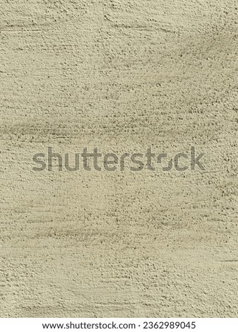 Beige wall, texture, background. Greenish beige building wall, painted with water-based paint. Unevenly plastered wall surface in peach color. Rough backdrop in vintage color. Shabby, dirty surface
