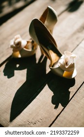 Beige Wedding Shoes On A Wooden Windowsill.