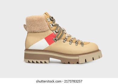 Beige women's fashion combat boot isolated on white background. Female classic autumn Timberland shoe. Leather laced, lace up casual footwear with metal rivets, rough sole, fur outside. Template - Shutterstock ID 2173783257