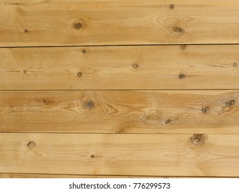 beige wood board texture with knots useful as a background