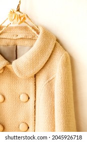 Beige Wool Coat Hanging On Clothes Hanger On White Background.Close Up.