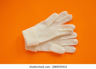 Beige Wool Gloves, Pair Of Beige Gloves Isolated On Orange Background.