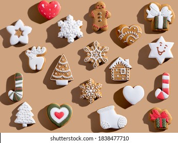 Beige Xmas background. Gingerbread biscuit pattern. Colorful winter holidays bakery food ornament. Homemade cookie collection creative composition isolated on light brown. - Powered by Shutterstock