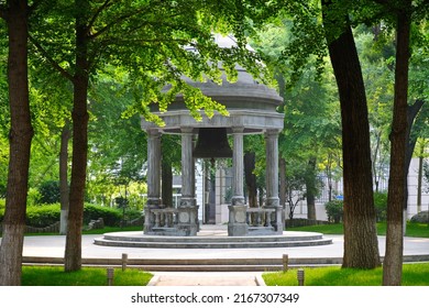 Beijing, China - 05.11.2019 : Stone Gazebo With An Old Bell In The Center Of The City Square.