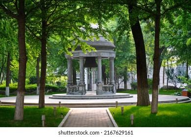 Beijing, China - 05.11.2019 : Stone Gazebo With An Old Bell In The Center Of The City Square.