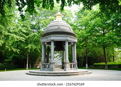 Beijing, China - 05.11.2019 : Stone Gazebo With An Old Bell In The Center Of The City Square.