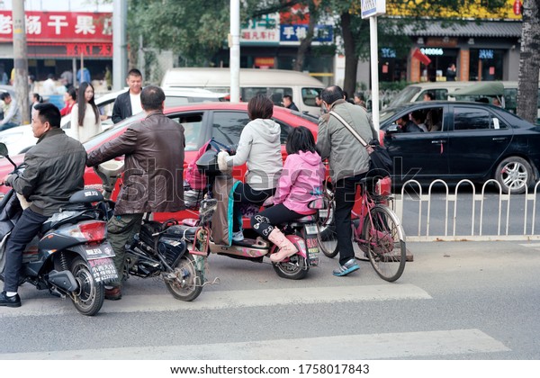 Beijing, China - 06 October 2016: The bike riders\
cross the street.