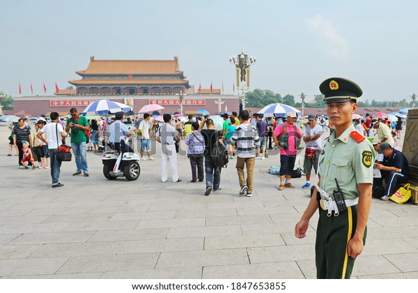 Beijing / China - 08.06.2012 : A security officer\
passes through Tiananmen\
square