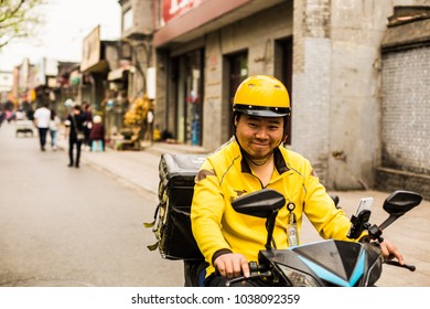 BEIJING, CHINA - 16 APRIL 2017: Local Delivery Man On Scooter