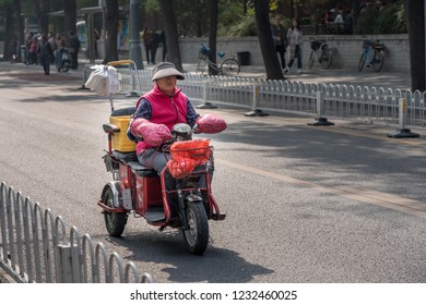 BEIJING, CHINA - 19 OCTOBER 2018: Electric Vehicle With Three Wheels For Street Cleaner Driving Down Road