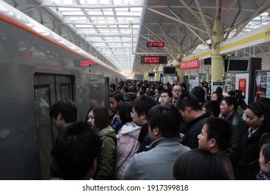 Beijing, China - 20 November 2011: Passengers Wait For Board The Train On The Crowded Platform In Xi-Zhi-Men Subway Station.