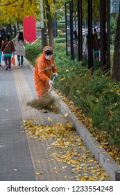 BEIJING, CHINA - 20 OCTOBER 2018: Street Cleaner Brushing Leaves In Central Business District